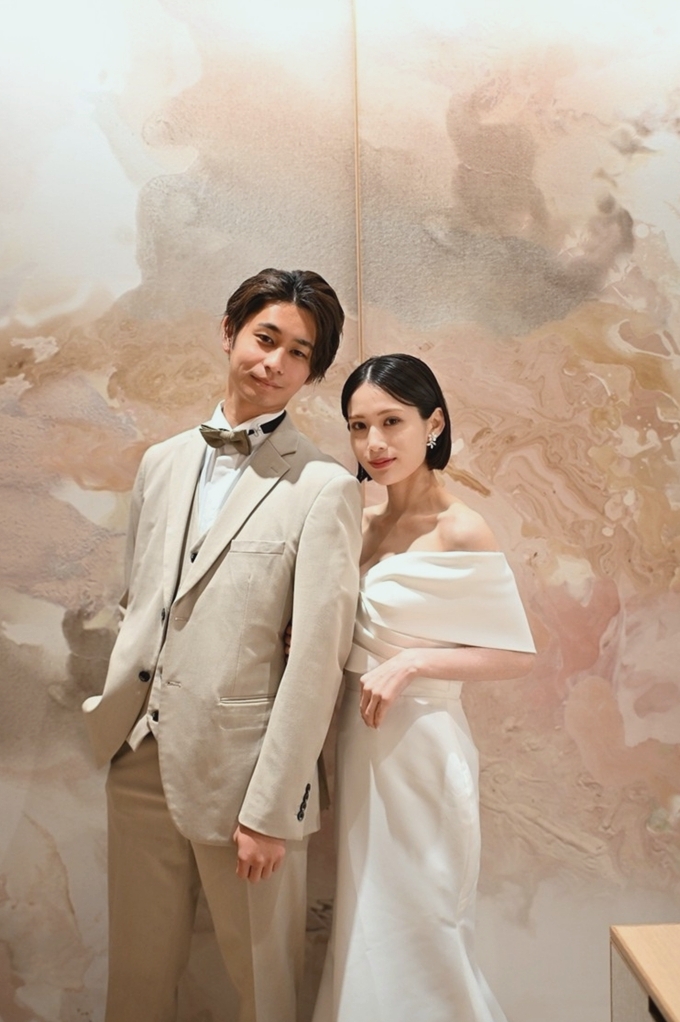 A couple with a feminine-toned modern art wall