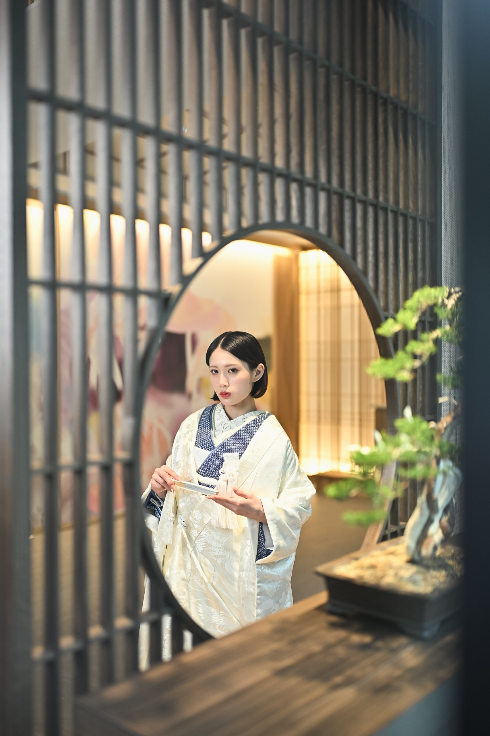 Bride holding a traditional Japanese wagasa umbrella in the Wa-Modern studio at Wedding Avenue Tokyo