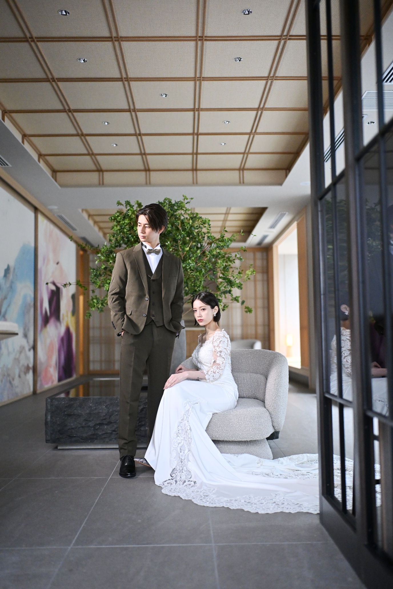 Bride in a white wedding dress standing in the Wa-Modern studio with bamboo and lattice backdrop