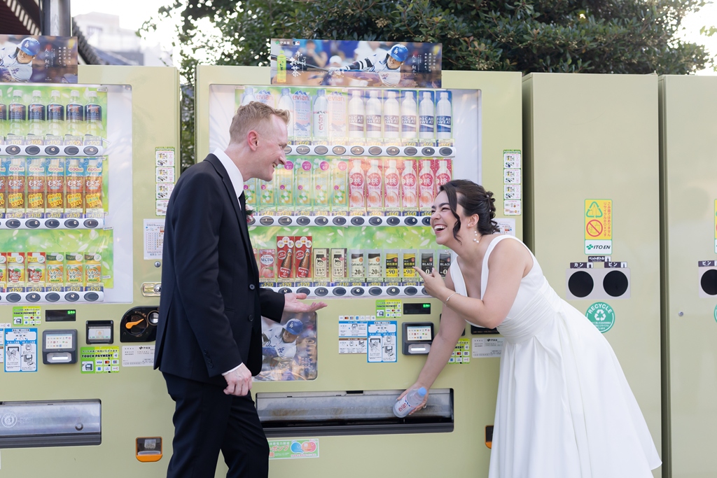 Sharing a laugh at a colorful Japanese vending machine, a candid and playful moment from their Japan wedding photography adventure.