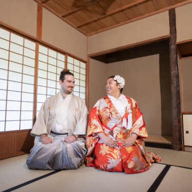 Bride and groom in kimono sitting side by side on the tatami floor of a traditional Japanese room, a calm portrait from their pre-wedding photoshoot at Sankeien Garden