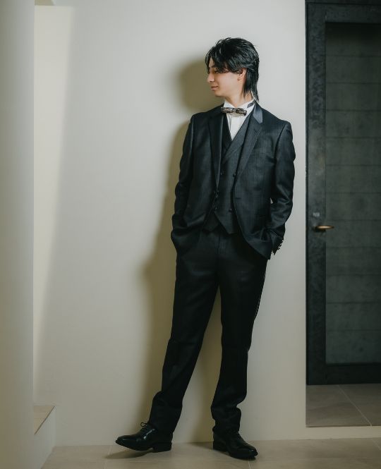 Noir Blue style wedding dress (DR01): This noir blue tuxedo captures the calm depth of the ocean with a subtle, captivating sheen. Its
																tailored silhouette and refined craftsmanship create an effortlessly elegant presence. A double-breasted
																vest adds a distinctive, sophisticated touch inspired by our Minami-Aoyama collection.
