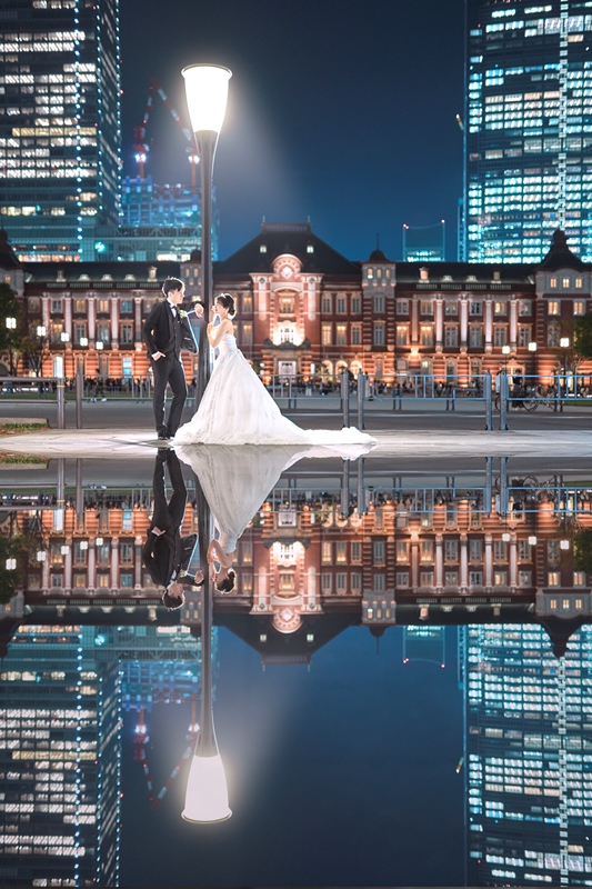 The back of a wedding dress and the bride's profile reflected in a mirror