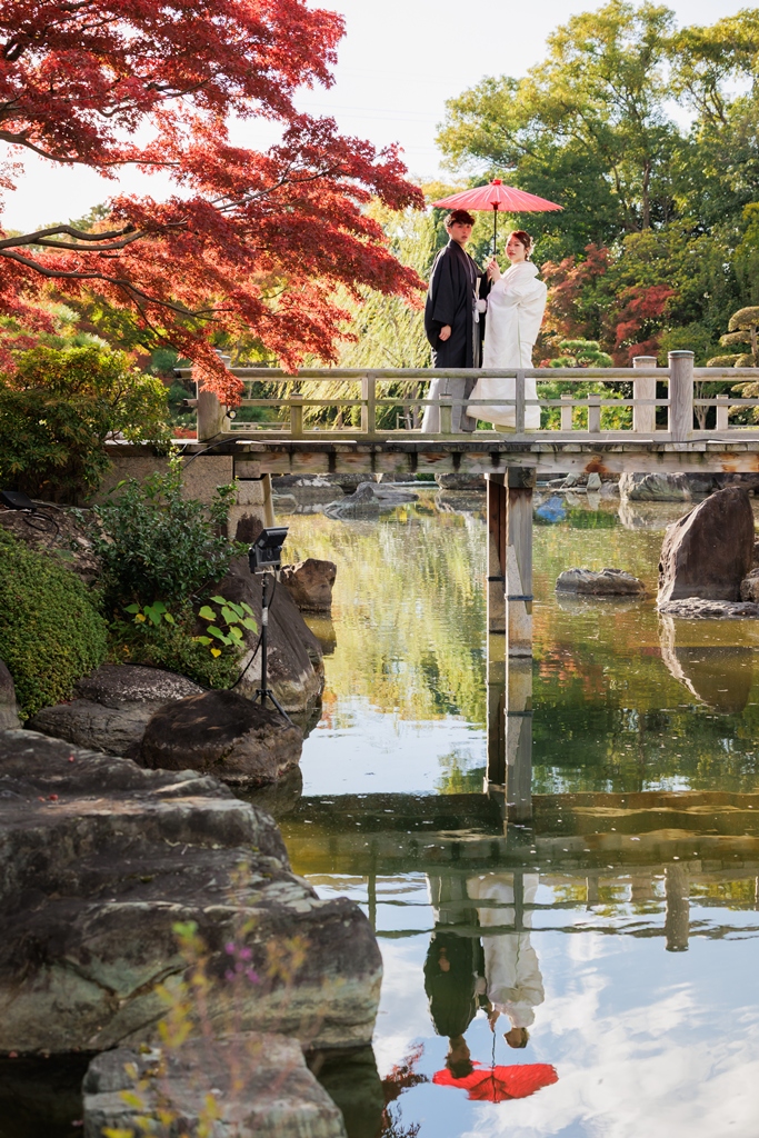 A couple embracing by the water at sunset