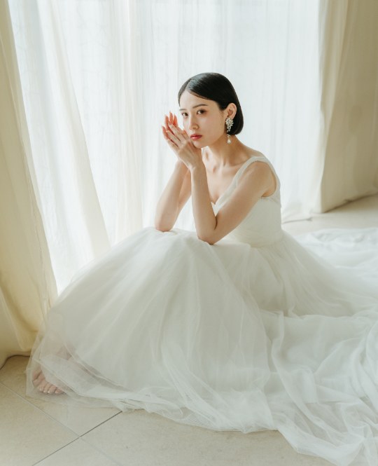 Bride seated in a Morilee soft tulle princess-line wedding dress (DB05), pre-wedding photoshoot in Japan at our Tokyo Omotesando studio.