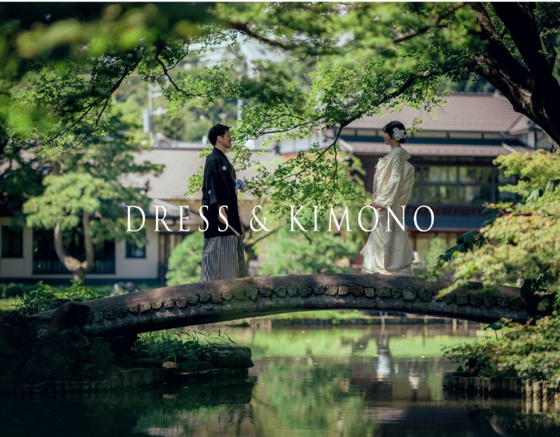 'Dress & Kimono' banner: groom in black montsuki and bride in cream kimono face each other on a garden bridge.